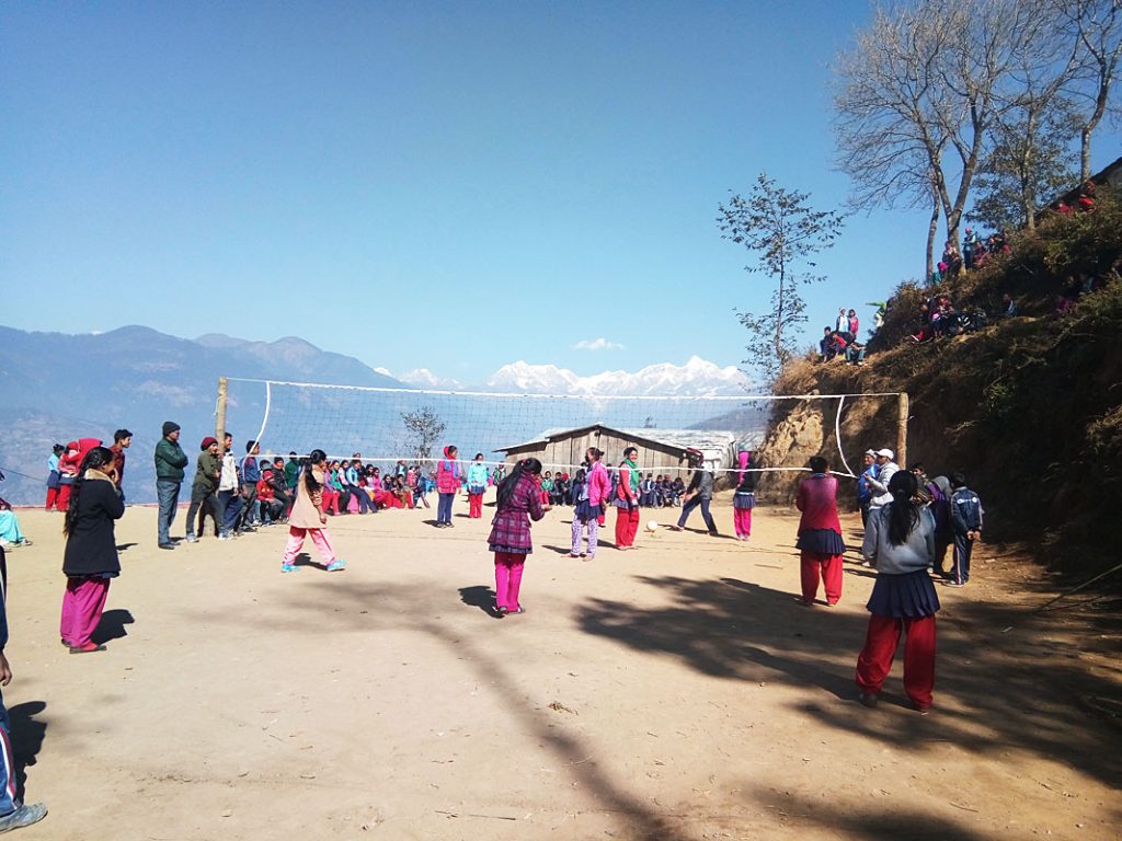 Girls playing volleyball in front of Solokhumbu